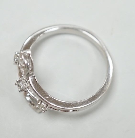 A modern 18k white metal and seven stone diamond chip set petal ring, size L, gross weight 3.3 grams.
